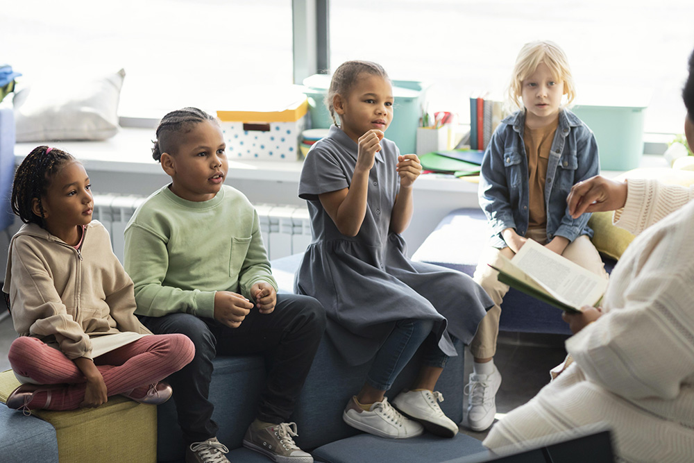 Preschool teacher reading to students