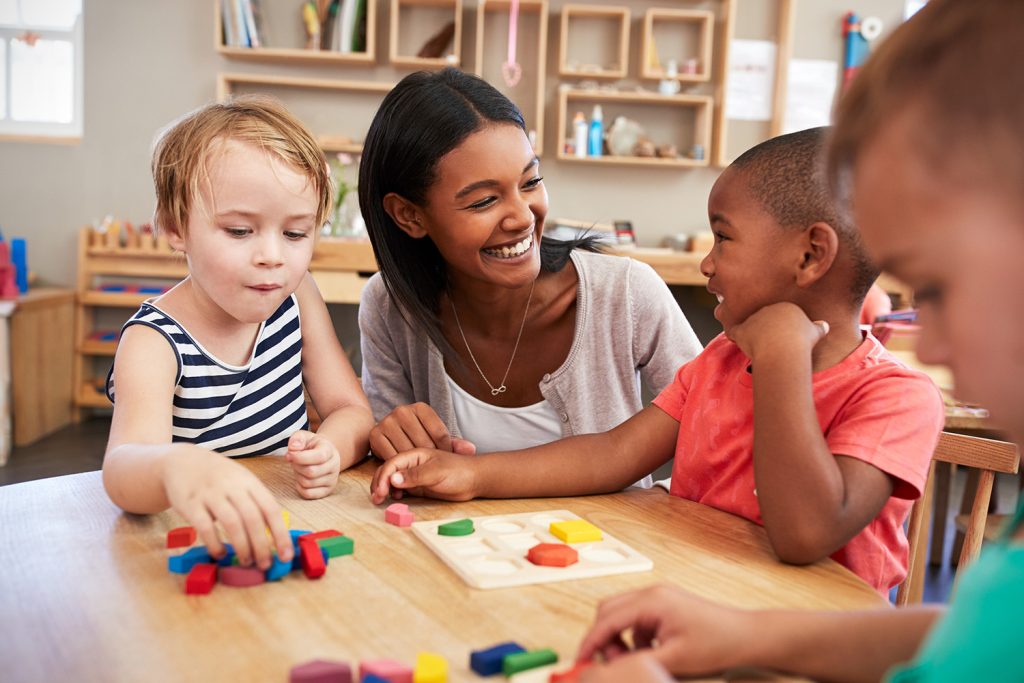 Certified preschool teacher with students